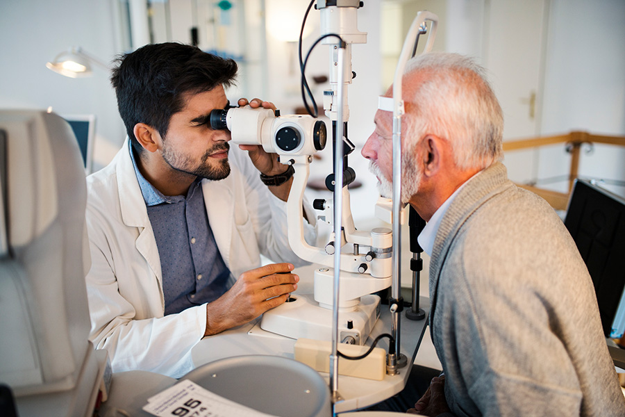 Eye doctor performing an eye test on a patient with diabetes to screen for glaucoma and other conditions