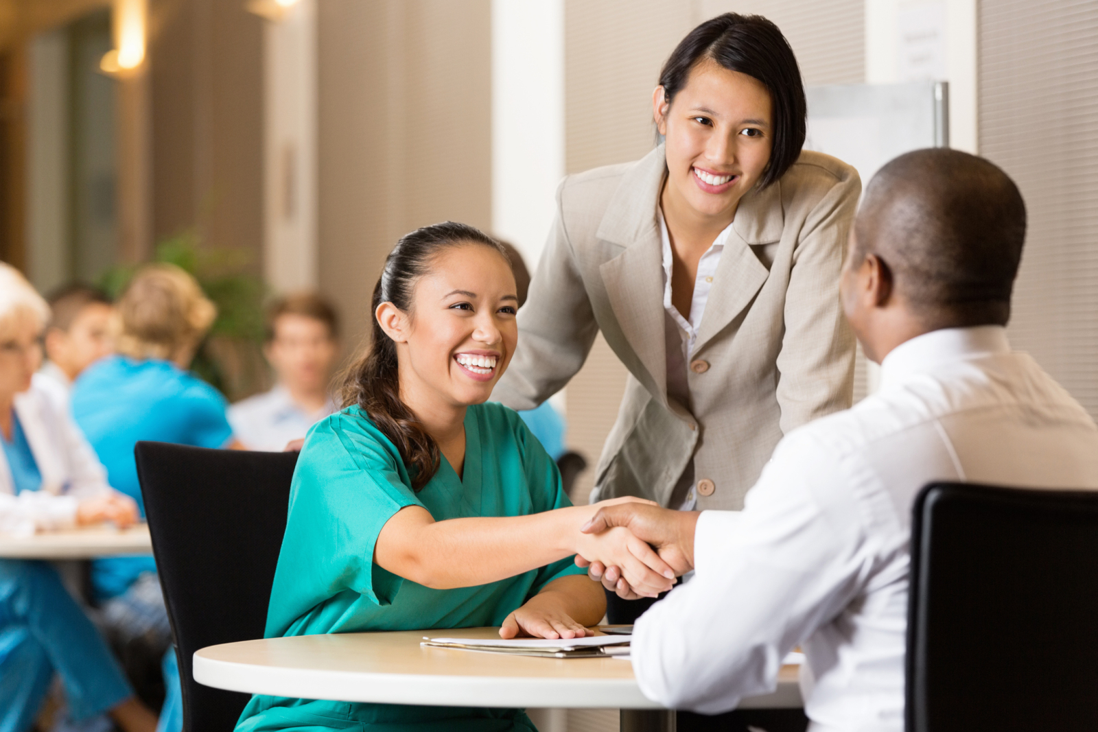 Female student shakes hands with recruiter during a job interview